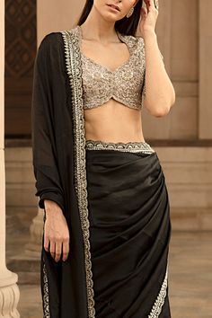 Black saree with zardozi embroidery. Comes with blouse.
Components:2
Embroidery
Neckline:Leaf
Sleeve Length:Short
Fabric:Silk
Color:Black
Sequin and cutdana embroidery on blouse
Scallop hems on saree - Aza Fashions Anarkali Blouse Piece With Zari Work For Evening, Anarkali Style Evening Blouse Piece With Zari Work, Anarkali Blouse Piece With Dupatta For Evening, Anarkali Embroidered Blouse Piece For Evening, Traditional Wear With Resham Embroidery For Evening, Traditional Evening Wear With Resham Embroidery, Traditional Wear With Intricate Embroidery For Evening, Traditional Saree For Evening Wear, Traditional Evening Wear With Intricate Embroidery