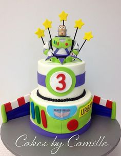 a three tiered birthday cake with cars and stars on top