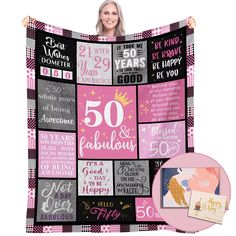 a woman holding up a pink and black blanket with the words 50 years on it