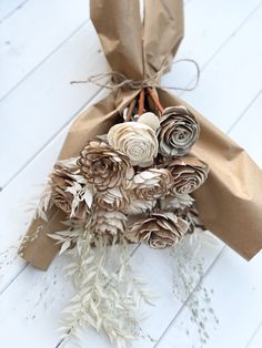 a bouquet of flowers wrapped in brown paper