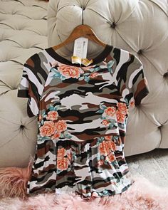 A cozy camo & rose print adorns this sweet tee. Designed with a soft shape, ruffle hem & contract trimmed neck & sleeves. Perfect paired with jeans and a hoodie for the season. Color: Camo Imported Hand wash cold split Small Medium Large Bust 36 38 40 Waist 35 37 39 Hips 38 39 40 Length 28 28 28 Bust, waist, and hip measurements are a total circumference. Length is measured from the top of the tee to the hem. Measurements are an estimate. Rose Details, Batman Kids, Sweet Tee, Rosé Details, Large Bust, Season Colors, Rose Print, Boys T Shirts, Ruffle Hem