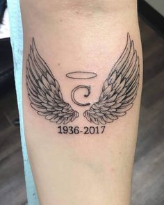 a black and white photo of a tattoo with wings on the leg that reads 5 year anniversary