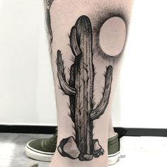 a black and white photo of a cactus on the leg