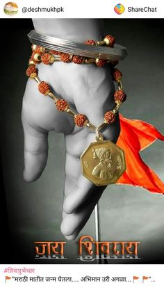 a person holding onto a gold coin with a red flag in the background