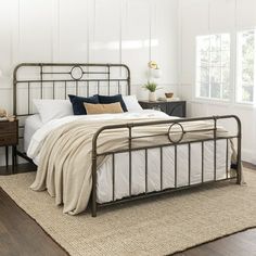 a bedroom with white walls and wood floors