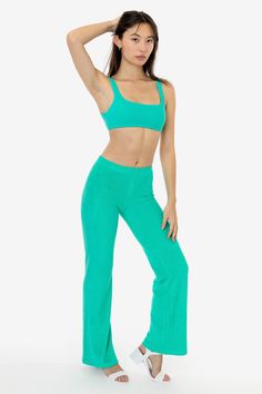 These versatile loop terry pants will elevate your loungewear or make the perfect layering piece after the beach. They feature a low to mid-rise fit and flared leg for a dressier look when desired. Pair with one of our bodysuits or matching loop terry tops for a fun dinner outfit or one of our matching baby tees for a more casual approach. Our loop terry has a subtle, natural stretch and a stretchy elastic waistband make for a comfortable fit for any occasion. This garment is intended to sit jus Solid Flare Yoga Pants For Loungewear, Casual Flare Yoga Pants For Loungewear, Summer Full-length Sweatpants For Loungewear, Summer Loungewear Sweatpants, Summer Stretch Sweatpants For Lounging, Sporty Flared Bottoms For Loungewear, Sporty Flare Pants For Loungewear, Spring Flare Yoga Pants For Loungewear, Sporty Flare Lounge Pants