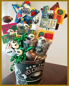 a bucket filled with sports themed items on top of a table