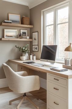 a desk with a computer on top of it in front of a window and shelves