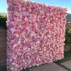 a large pink flowered wall in front of a house