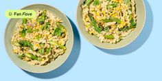 two bowls filled with rice and vegetables on top of a blue background, next to each other