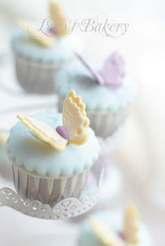 cupcakes with blue frosting and yellow decorations