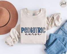 a shirt that says pediatric nurse next to jeans and hat