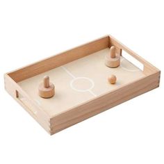 two wooden pegs are placed on top of a board game that is ready to be played