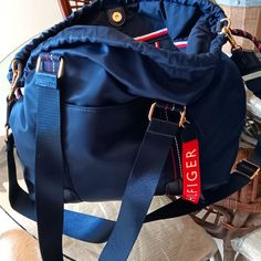 This Beautiful Duffel Bag Can Be Used For A Handbag, Or Overnight Nylon Bag Bnwt Navy Nylon Bags For On-the-go, Navy Shoulder Bag With Top Carry Handle For On-the-go, Blue Bucket Bag With Top Carry Handle For Travel, Navy Crossbody Travel Bag, Navy Shoulder Bag With Detachable Strap For Travel, Tommy Hilfiger Tote Shoulder Bag For Everyday Use, Navy Crossbody Shoulder Bag For Travel, Tommy Hilfiger Shoulder Bag With Removable Pouch, Navy Nylon Bags With Adjustable Strap