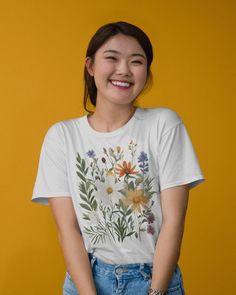 Embrace the beauty of nature with our Floral Bouquet T-Shirt! This lovely tee features a stunning bouquet of flowers on the front, perfect for anyone who loves the elegance and charm of floral designs. Ideal for casual wear, garden parties, or as a thoughtful gift for nature and garden enthusiasts. The unisex soft-style t-shirt puts a new spin on casual comfort. Made from very soft materials, this tee is 100% cotton for solid colors. Heather colors and sports grey include polyester. The shoulder Nature-inspired T-shirt With Plants Print For Summer, Nature-inspired Summer T-shirt With Plant Print, White Botanical T-shirt With Floral Print, White Botanical Floral Print T-shirt, White T-shirt With Botanical Print, White Floral Print T-shirt, Botanical Flower Graphic Print T-shirt, Botanical Style Flower Graphic T-shirt, Garden Parties