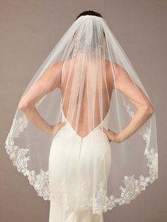 the back of a woman wearing a wedding veil