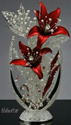 a glass sculpture with red flowers and pearls on it's base, sitting on a table