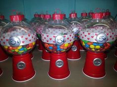 there are many candy dispensers in the shape of gummy balls on top of each other