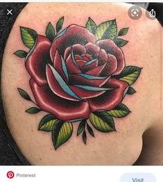 a woman's shoulder with a rose tattoo on it