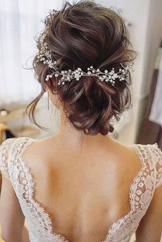 the back of a woman's head wearing a wedding dress