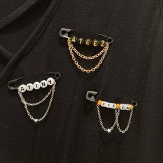 three different types of hair clips with chains attached to them, sitting on top of each other