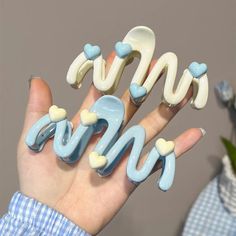 Transform Your Look with the Trendy Wavy 3D Heart Hair Clip! 🌊✨ Stylish & Modern Design ️🎨 Elevate your hair game with our Wavy Hair Clip Set, featuring a chic and unique wave pattern with 3D hearts that perfectly complements any hairstyle. These clips are not just functional; they're a fashion statement. Available in soft pastel shades of baby blue and frosted white, these clips add a touch of elegance and fun to your daily look. Whether you're dressing up for a special occasion or adding fla Aesthetic Claw Clip, Korean Hair Clip, Heart Wave, Korean Hair, Stylish Aesthetic, Hair Accessories Collection, Hair Clamps, 3d Heart, Fresh Hair