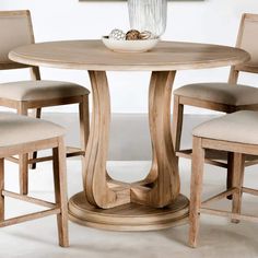 a round table with chairs around it and a bowl on top of the table,