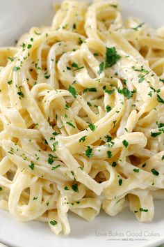 a white bowl filled with pasta on top of a table