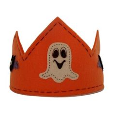 a small orange crown with a ghost on it's face and two black eyes