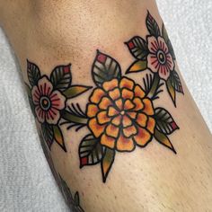 a close up of a person's foot with a flower tattoo design on it