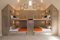 there are two bunk beds in this room with orange pillows on them and white carpet