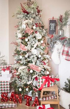 a christmas tree decorated with red and white ribbon