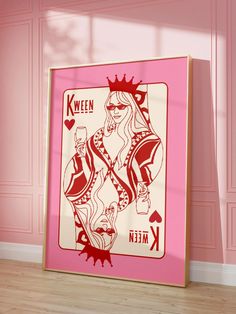 a pink and white ace playing card on a wooden floor in front of a pink wall