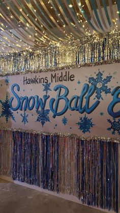 a sign that says hawks middle snow ball 3 hanging from the ceiling with streamers