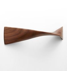 a wooden spoon on a white surface with no one in the photo looking at it