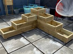 a group of wooden steps sitting on top of a cement floor next to a white chair