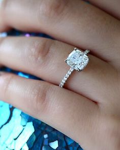 a woman's hand with a diamond ring on it