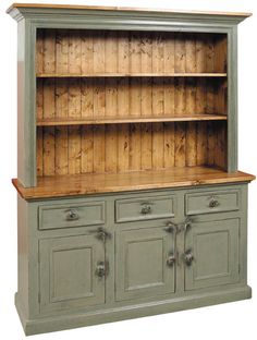 an old dresser with wooden shelves and drawers on it's sides, painted green