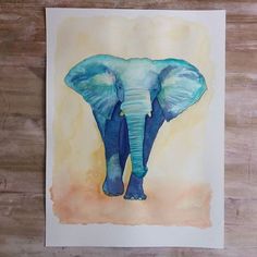 an elephant is painted on a piece of paper with watercolors and pastel