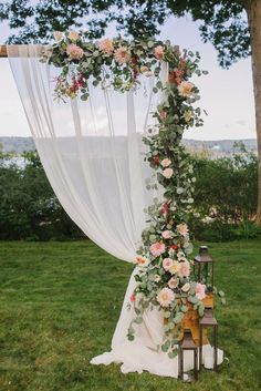 the wedding arch is decorated with flowers and greenery for an outdoor ceremony or reception