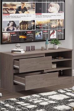 an entertainment center with two drawers and a flat screen tv mounted on the wall above it