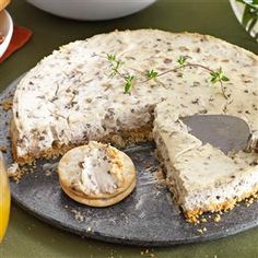 there is a cake that has been cut into pieces and served with cookies on the side