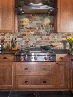 a stove top oven sitting inside of a kitchen next to wooden cupboards and counter tops