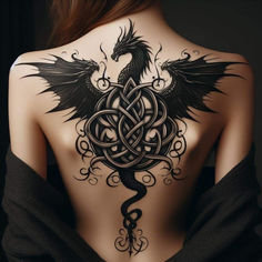 a woman's back with an intricate tattoo design on it