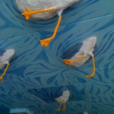 three white birds with yellow beaks are painted on the ceiling