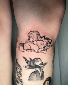 tattoos on the leg of a woman with disney characters and their names in black ink