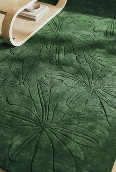 a green rug with an intricate design on it