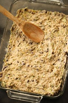 a casserole dish with a wooden spoon in it