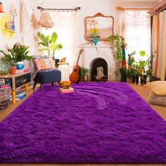 a living room with purple rugs and various plants in the corner on the floor