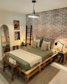 a bedroom with a brick wall and wooden furniture in the corner, along with a bed made out of pallets